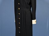 an image of a woman ' s coat and dress on a mannequin stand