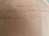 an old envelope with a handwritten message on it sitting on top of a table