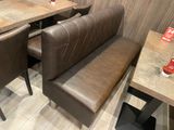 a booth with a bench and a table in the corner