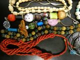 a lot of beads and necklaces on a table