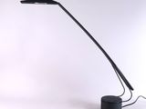 a black lamp that is sitting on a table