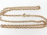 a close up of a gold chain on a white background