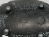 a black sculpture of a bear with a tag on it ' s neck