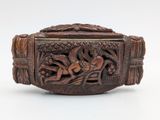 an antique carved wooden box with a design of a woman on a boat