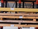 a wooden rack with several pairs of scissors hanging from it