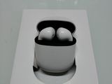 a white box with a pair of airpods in it