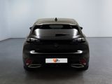 the rear end of a black car in a room with a white wall