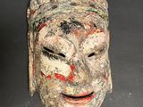 an image of a wooden mask on a table