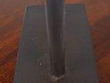 a close up of a metal object on a wooden table