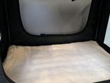 a black bag with a white blanket inside of it