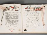 an open book with a drawing of a dragon on it