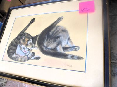 a picture of two cats that are sitting on a table