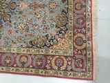 a rug on the floor with a red and blue border