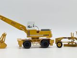 a toy truck and a bulldozer on a white surface