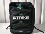 a black bag with a green arrow on it sitting on a table