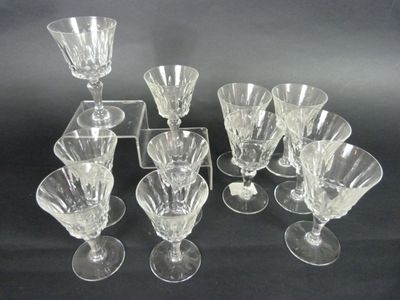 six clear glass wine glasses and a tray on a black background