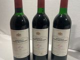 three bottles of wine sitting on top of a table next to each other