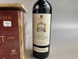 a bottle of wine sitting next to a box of wine