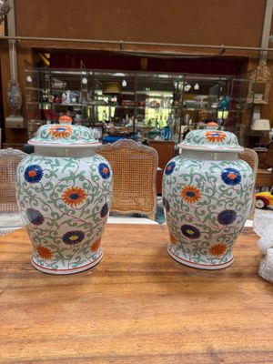 two vases that are sitting on a table