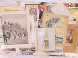 a lot of old photographs and postcards on the table