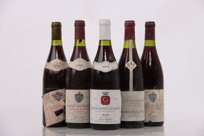 several bottles of wine are lined up on a table