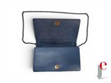 a close up of a blue purse with a chain around it