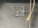 a piece of wood with a rope hanging from it ' s side