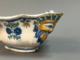 a blue and white bowl with yellow flowers on it