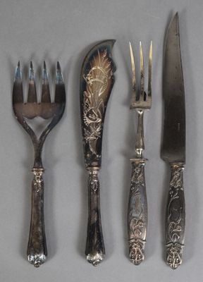 four forks, a knife, and a spoon are lined up on a table