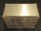 a metal chest with three drawers and a mirror on top of it