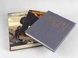 two books sitting on top of each other on a white surface