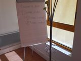 a white board that is on a stand in front of a window