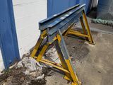 a metal bench sitting in front of a blue door