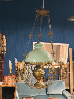 an image of a living room with a blue couch and a chandelier