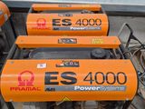 three electric generators sitting on top of a pallet in a warehouse