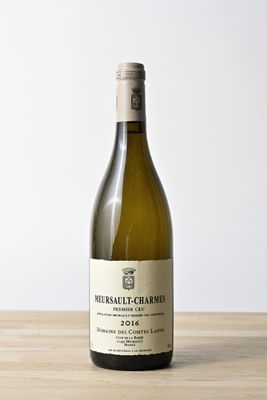 a bottle of wine sitting on a wooden table