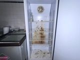 an image of a dirty refrigerator in a small kitchen
