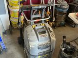 une photo d'un garage avec un aspirateur et d'autres outils
