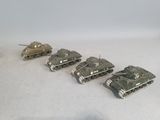 six toy tanks lined up in a row on a table