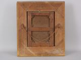 an old wooden picture frame with a chain hanging from it