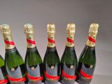 six bottles of champagne are lined up in a row on a table