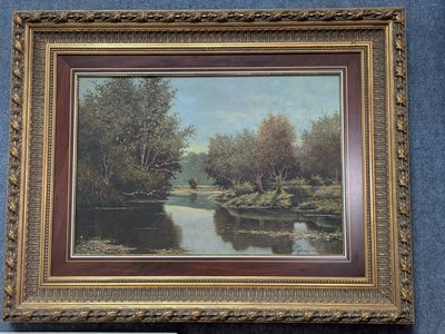 an image of a painting of a river in a gold frame on a blue wall