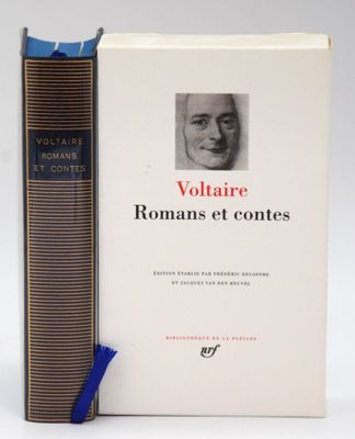 two books sitting next to each other on a white surface