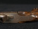 pair of antique wooden hunting pistols on a black background