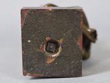 a small metal object that is sitting on a white surface