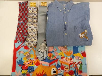 a lot of men ' s shirts and ties laid out on a table