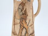 a brown pitcher with a picture of a man on it