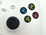 a close up of a video game controller on a white surface