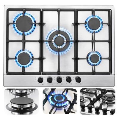 four burners on a gas stove with blue flames