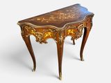 an image of a small table with a wooden top and gold decorations